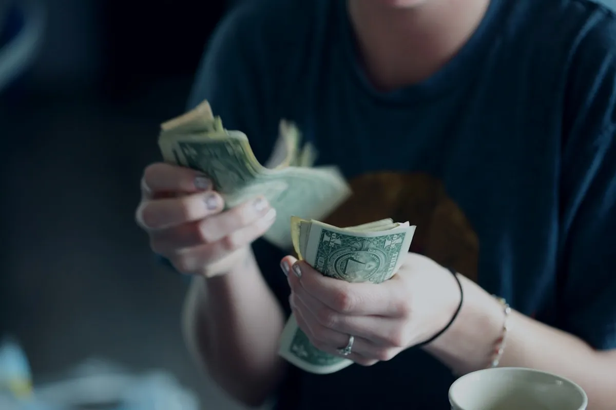 Person counting cash from a beneficiary advance