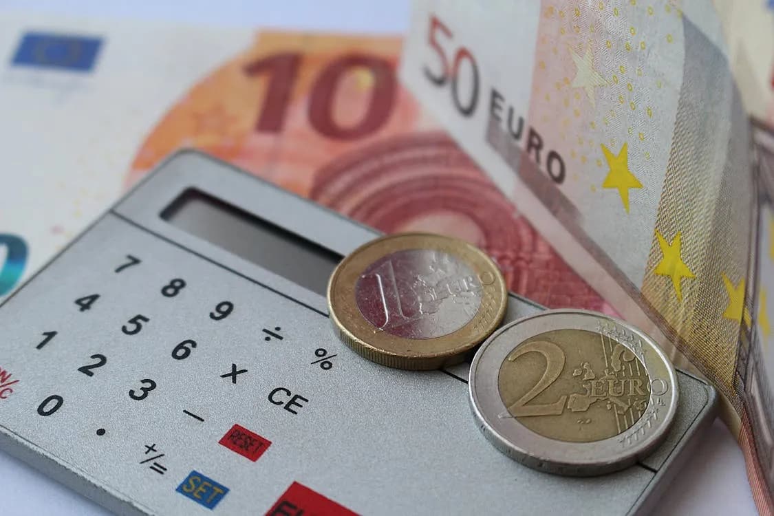Calculator with money representing inheritance advance costs